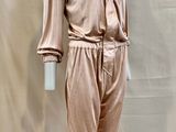 an image of a mannequin wearing a pink suit on a mannequin stand