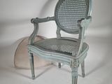 a chair with a cushion on the floor next to it