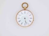 a gold pocket watch with roman numerals on the face