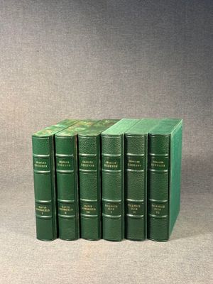 six green books stacked on top of each other on a table