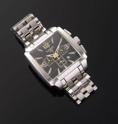 a close up of a watch on a black surface