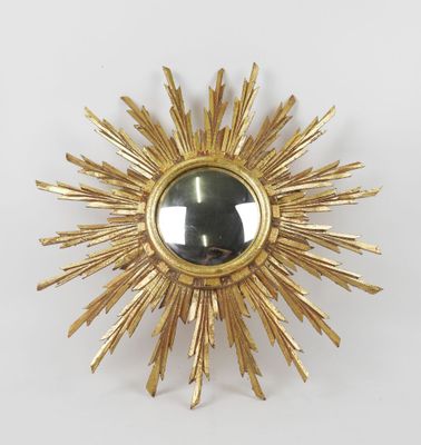 an image of a gold sunburst with a mirror in the middle
