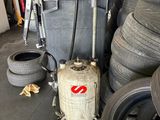 a large pot on top of a propanent in a garage