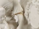 a white statue of a woman holding a child