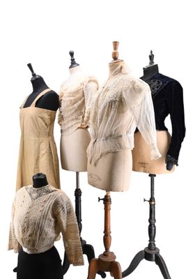 three mannequins are lined up in a row with dresses on them