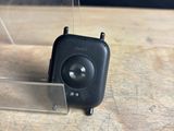 a small black object sitting on a wooden table