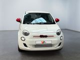 white fiat car parked in a white room with a black floor