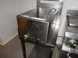 a stainless steel sink and a stainless steel stove in a kitchen