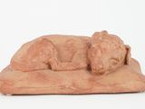 figurine of a sleeping dog on a pillow
