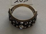 a close up of a ring on a white surface with a price tag