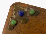 a close up of a wooden table with two blue and green buttons