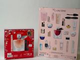 two boxes of perfumes on a white surface