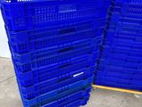 two blue plastic crates stacked on top of each other