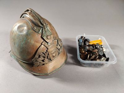 a metal helmet and a container of screws on a table