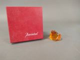 a small orange bear sitting next to a red box
