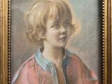portrait of a young girl in a pink dress by a gold frame
