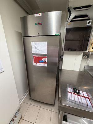 a stainless steel refrigerator in a kitchen with a lot of counter space