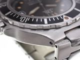 a close up of a watch on a white surface
