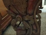 a wooden bench with carvings on it in a room
