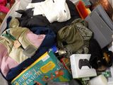 a suitcase full of clothes and books on the floor