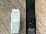 a remote control next to a remote control on a wooden floor