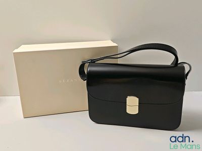 an image of a black bag and a box on a table