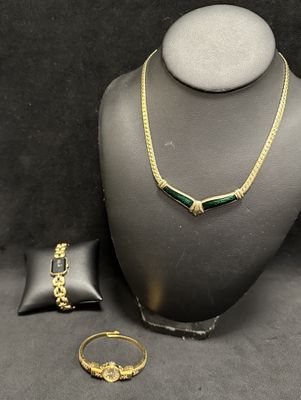 a necklace, bracelet, and ring are on display on a mannequin