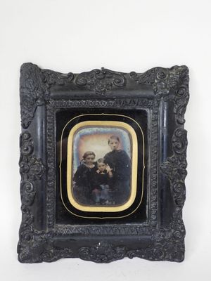 an old picture of a group of people in a picture frame
