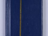 a blue notebook with a yellow stripe on the cover