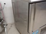 a stainless steel refrigerator and a shopping cart in a room