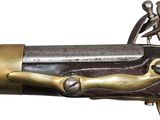 an old gun with a brass handle on a white background