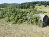 a large barrel sitting in the middle of a field