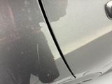 a reflection of a man in a mirror on the side of a car