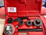 Quelqu'un tient une boîte à outils rouge contenant des outils.