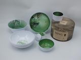 a lot of green and white bowls and bowls on the table