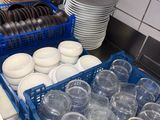 a lot of empty plastic cups and plates in the kitchen