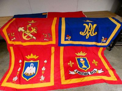 a red and blue blanket with a coat of arms on it