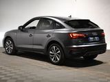 the audi q3 is parked in a garage with a checkered floor