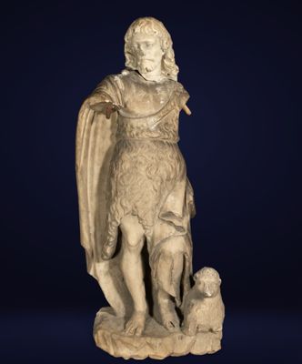 an old statue of a man with a dog on a blue background