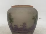 a small vase that has a picture of a landscape on it