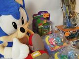 sonic the hedger plush toy sitting on a table next to other toys
