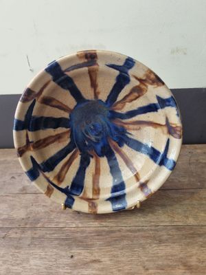 a blue and white bowl sitting on a wooden table