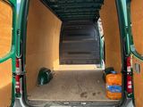 a green van with two doors open on the side of the road