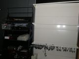 a small room with a closet and a shelf full of items