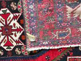 a cat that is sitting on a pile of rugs