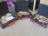 three black boxes with silver and gold items in them