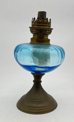 an image of a blue glass vase with a gold crown on top