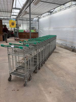 many shopping carts lined up inside of a building