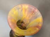 a glass vase with a yellow and red design on it