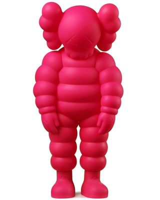 pink inflatable figure of a man standing on a white surface